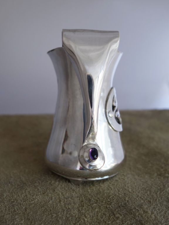 Silver pitcher with amethyst ornament (handle view)
