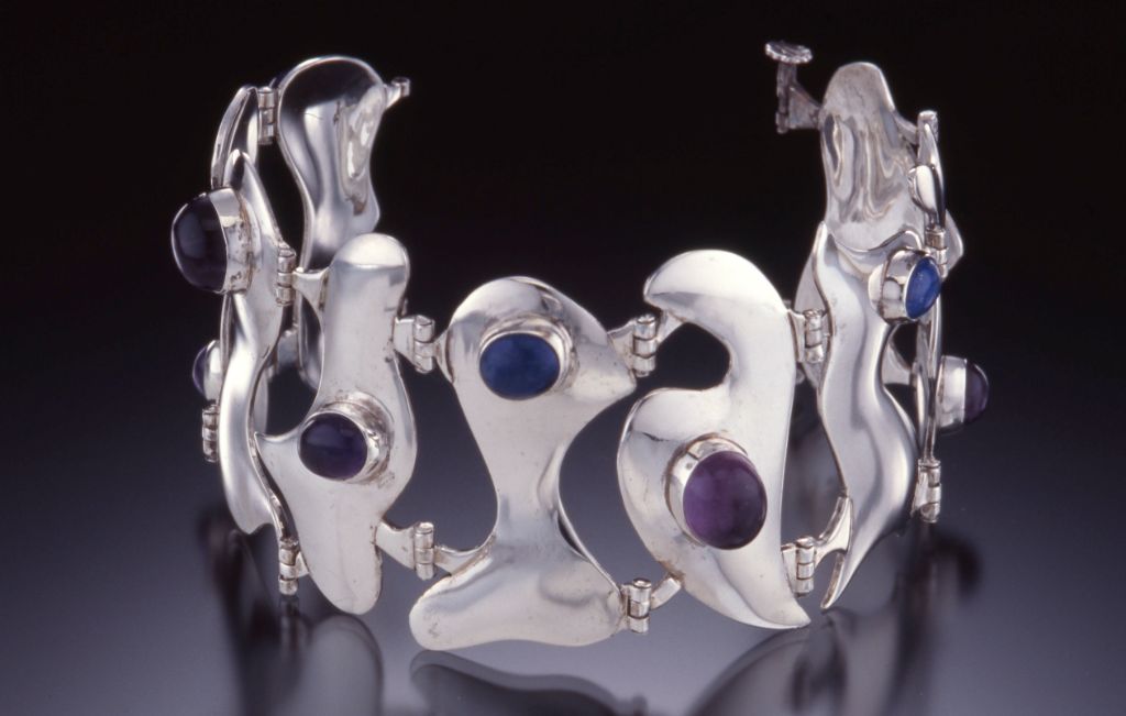Hinged bracelet. Silver forms with lapis and amethyst.